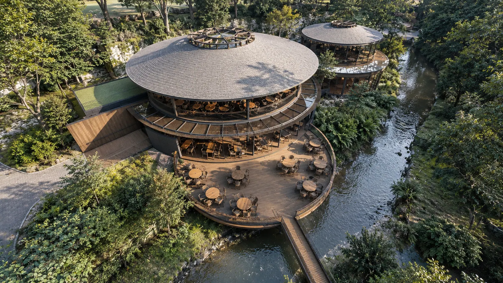 Enchanting Valley, Bogor: a round timber pavilion and deck beside the river in the forest